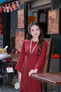 Elegant Vietnamese Beauty: A Girl in Red Ao Dai with Lilies Captivates Urban Charm-1