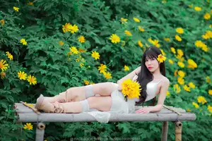 Graceful Young Woman in White Dress Amidst Vibrant Yellow Flowers 1000026997-5