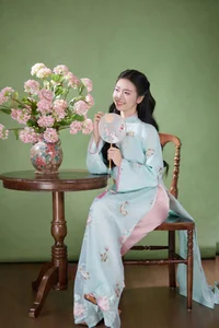 Radiant Elegance in Traditional Blue Attire and Spring Blooms-7