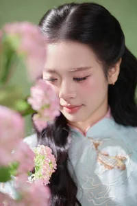 Radiant Elegance in Traditional Blue Attire and Spring Blooms-5