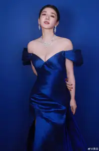 Radiant in Blue: A Woman's Elegant Charm Shines Bright in a Luxurious-5