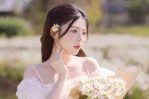 Serene Beauty: Young Woman in White Flower Field, Embracing Tranquility Under Gentle Sunlight-11