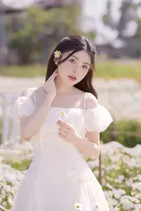 Serene Beauty: Young Woman in White Flower Field, Embracing Tranquility Under Gentle Sunlight-1