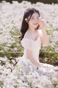 Serene Beauty: Young Woman in White Flower Field, Embracing Tranquility Under Gentle Sunlight-7