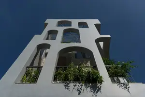 Light-Filled Tube House: Discover Unique Arched Facade & Green Urban Living-2