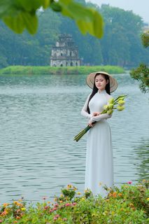 Vietnamese Ao Dai Beauty: Elegant Young Woman by Hoan Kiem Lake, Traditional Charm.-5