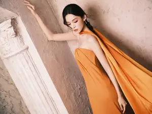 Captivating Beauty: Goddess in a Vibrant Orange Gown, Exuding Elegant Allure.-4