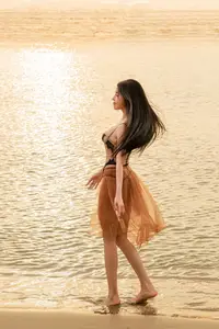 Golden Hour Serenity: Young Woman's Graceful Beach Walk-3