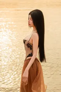 Golden Hour Serenity: Young Woman's Graceful Beach Walk-5