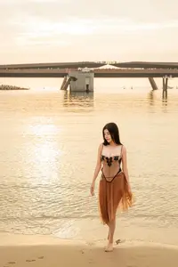 Golden Hour Serenity: Young Woman's Graceful Beach Walk-6