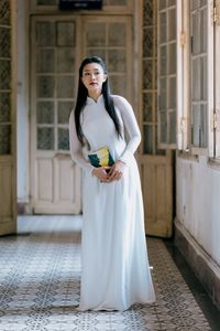 Graceful Vietnamese Girl in White Ao Dai by Window, Celebrating Traditional Beauty-12