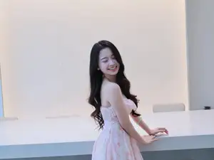 Gentle Charm: Beautiful Girl in Pink Floral Dress, Captivating Elegant Style.-3