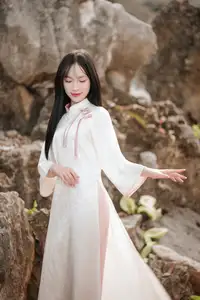 Timeless Elegance: Vietnamese Woman in Traditional Ao Dai Amidst Serene Backdrop-4