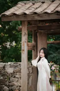 Timeless Elegance: Vietnamese Woman in Traditional Ao Dai Amidst Serene Backdrop-2