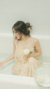 Ethereal Girl in Bathtub with White Flower: Serene Beauty & Relaxing Moment 1000018799.jpg-5