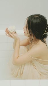 Ethereal Girl in Bathtub with White Flower: Serene Beauty & Relaxing Moment 1000018799.jpg-3