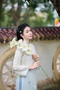 Graceful Ao Dai: The Ethereal Beauty of a Vietnamese Woman with White Orchids, Inspiring Tradition.-1