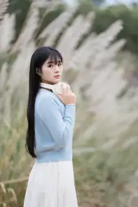 Explore Serene Beauty: Long-Haired Girl Immersed in Music Amidst Pampas Grass-3