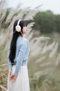 Explore Serene Beauty: Long-Haired Girl Immersed in Music Amidst Pampas Grass-7