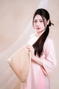 Vietnamese Beauty: Graceful in Traditional Pink Ao Dai and Conical Hat-0