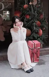 Elegant Girl in Off-Shoulder White Dress Welcoming Christmas, Showcasing Gentle Beauty and Holiday Season Style. 1000027390-4