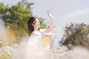 Ethereal Beauty: Young Woman in White Dress with Bouquet Amidst Dreamy Clouds-2
