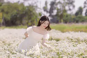 Ethereal Beauty: Young Woman in White Dress with Bouquet Amidst Dreamy Clouds-8