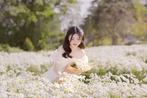 Ethereal Beauty: Young Woman in White Dress with Bouquet Amidst Dreamy Clouds-5