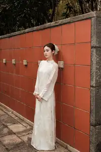 Gentle Elegance: Vietnamese Girl in Pure White Ao Dai with Hair Flowers - Traditional Beauty.-6