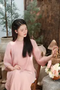 Discover Serene Vietnamese Beauty: Elegant Woman in Pink Linen Dress Amidst Floral Charm-0