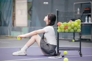 Pensive Break on Court: Young Tennis Player Recharges Energy After Intense Training Session-0