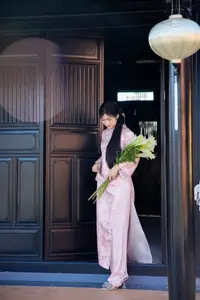 Graceful Asian Lady in Pink Ao Dai with Pristine White Lilies in Traditional Setting-3