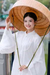 Graceful Vietnamese Beauty: A Serene Woman in White with a Lily-4