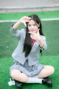 Cute Schoolgirl Frames a Moment on Green Grass-0