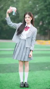 Cute Schoolgirl Frames a Moment on Green Grass-1