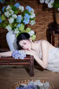 Ethereal Vietnamese Beauty: Graceful Asian Girl in Modern Yếm with Delicate Blooms.-7