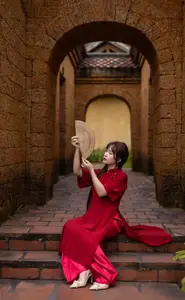 Discover the Timeless Elegance of a Vietnamese Woman in Red Ao Dai at Ancient Architecture.-4