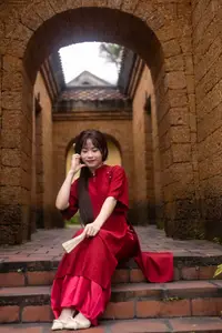 Discover the Timeless Elegance of a Vietnamese Woman in Red Ao Dai at Ancient Architecture.-1