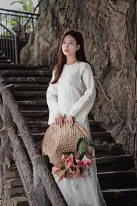 Elegant Vietnamese Beauty in White Ao Dai Serene Portrait with Pink Lilies on Ancient Stone Steps-4