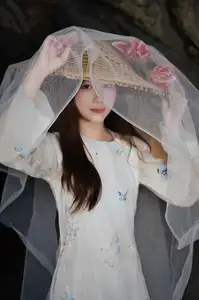 Elegant Vietnamese Beauty in White Ao Dai Serene Portrait with Pink Lilies on Ancient Stone Steps-1