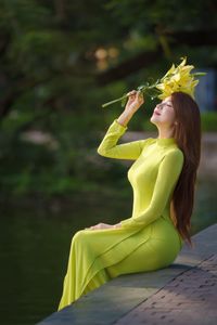 Serene Vietnamese Beauty: Woman in Ao Dai by the Lake-1