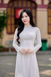 Captivating White Ao Dai: Elegant Vietnamese Girl in a Serene Moment, Timeless Beauty. Image ID: 1000019816.-1